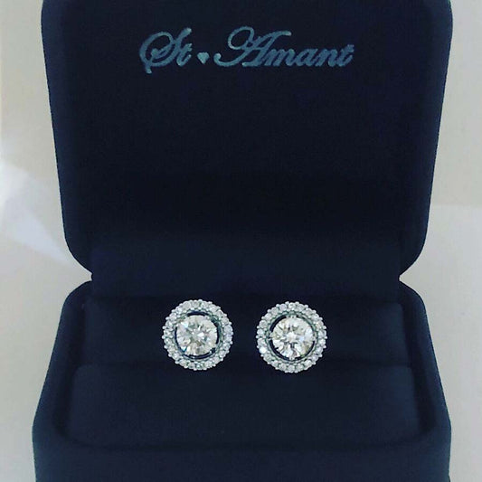 14kt White Gold Post Earrings Containing: 2 approx .60ct Round Diamonds In The Center Color H, Clarity VS; Approx .25ct Round Diamond Halo Jacket Color H, Clarity SI1; Approx 1.5ctw