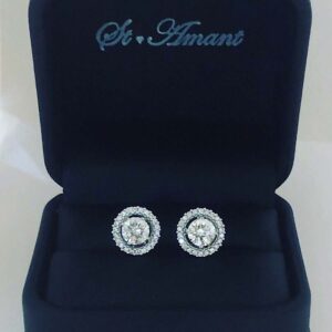 14kt White Gold Post Earrings Containing: 2 approx .60ct Round Diamonds In The Center Color H, Clarity VS; Approx .25ct Round Diamond Halo Jacket Color H, Clarity SI1; Approx 1.5ctw